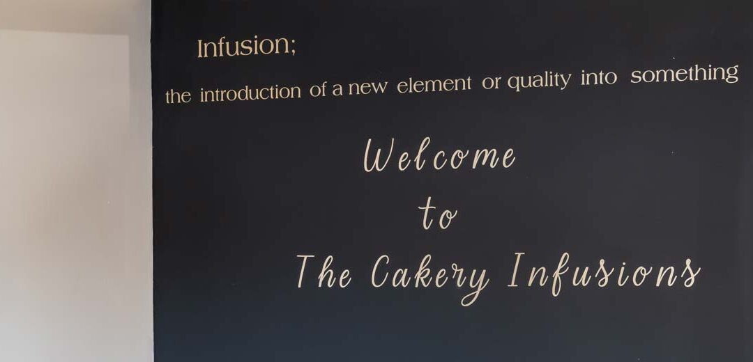 The Cakery Infusions welcome sign at the entrance