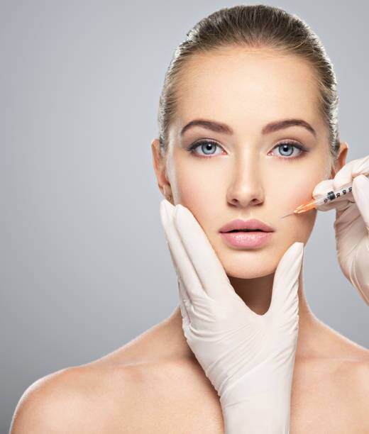 Person receiving a relaxing back massage at a spa a person recieving injectable filler