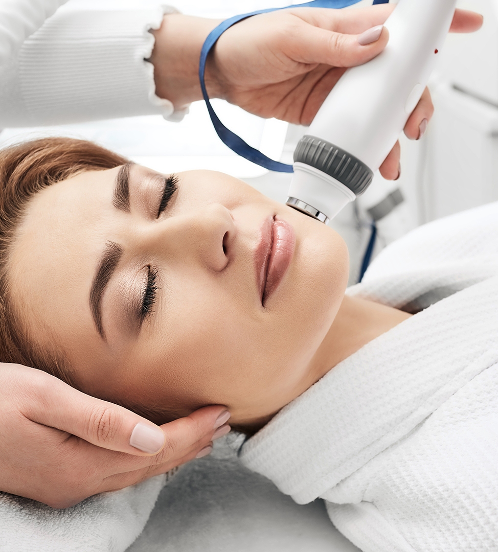 Radiofrequency skin tightening procedure in progress Aesthetician performing professional facial treatment