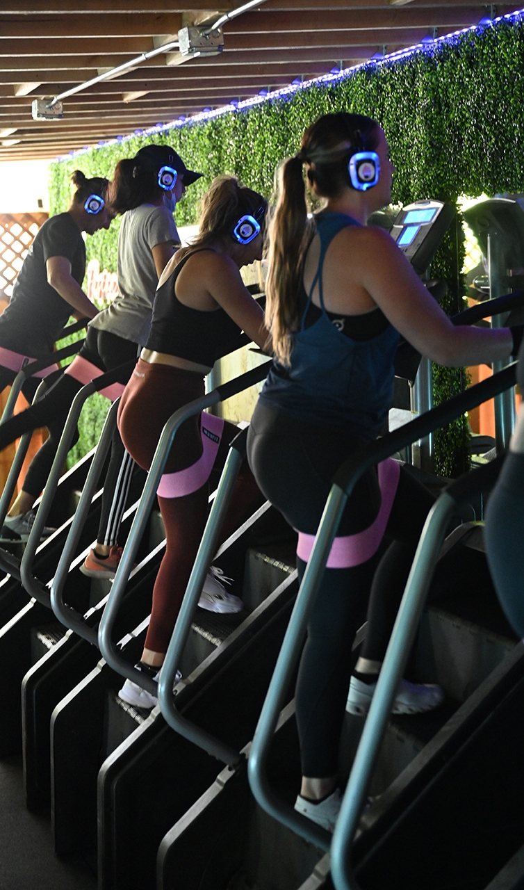 Step fusion fitness equipment in a modern gym a group of people doing stair workout